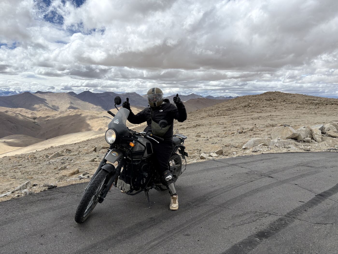 Anmol on a motorcycle on a high desert mountain road
