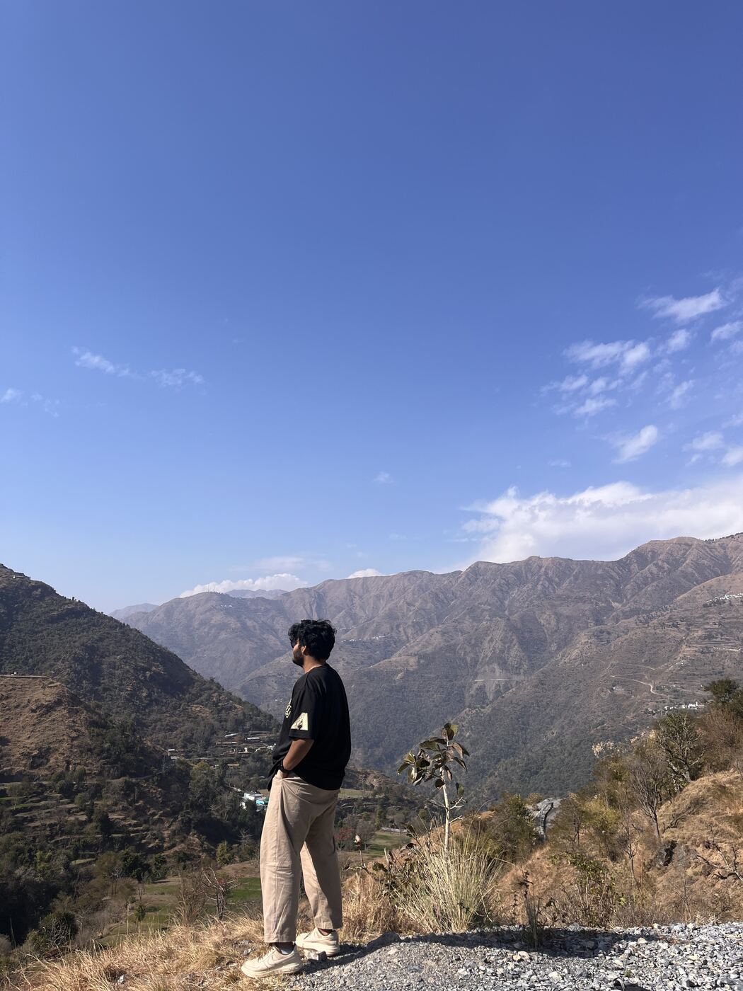 Anmol looking out over a mountain valley
