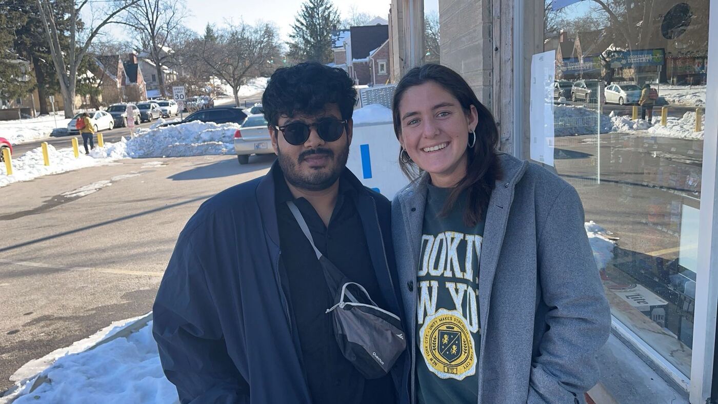 Anmol with a friend on a snowy street